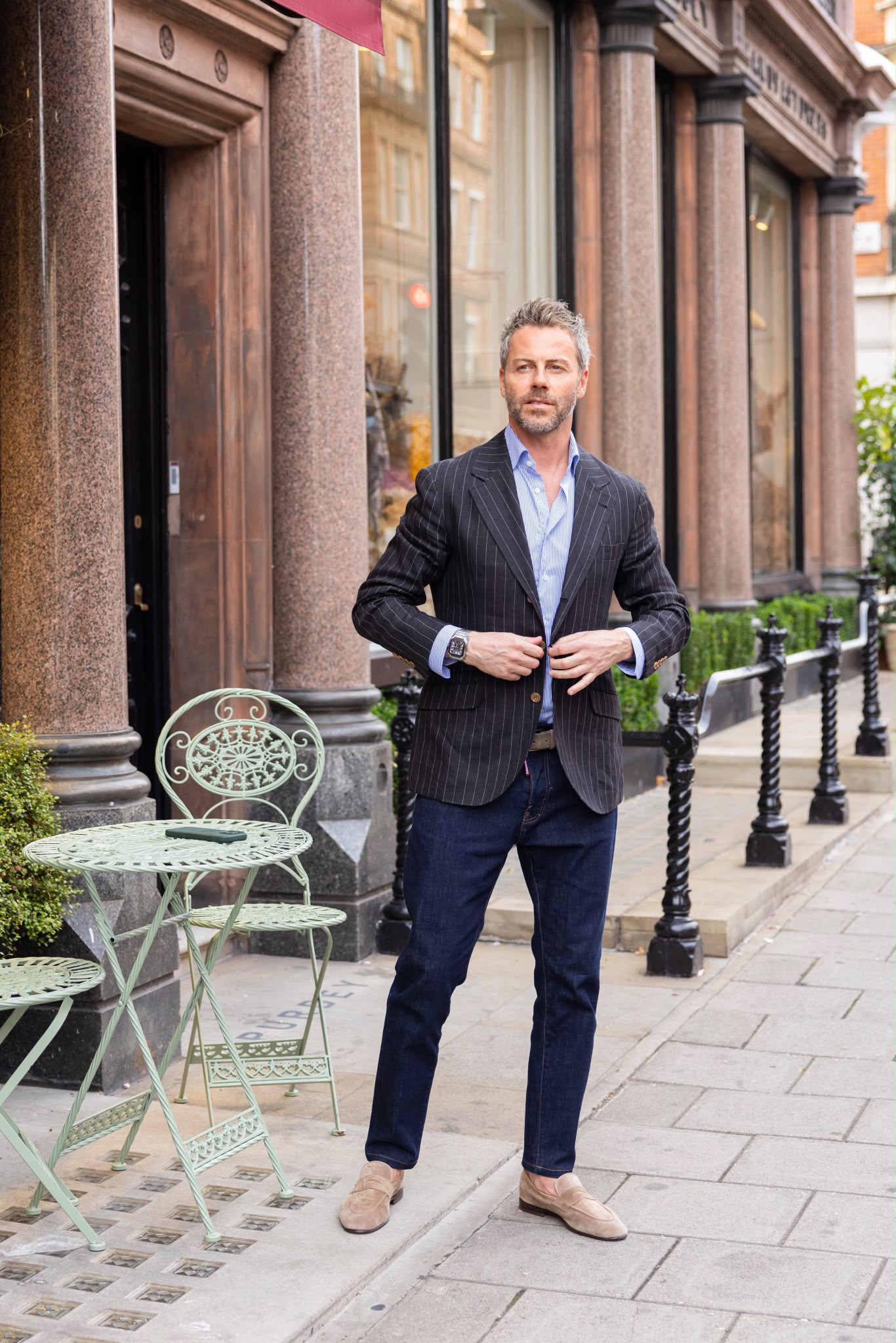 Gilberto Ramerini in a pinstripe blazer and jeans, outside a London café