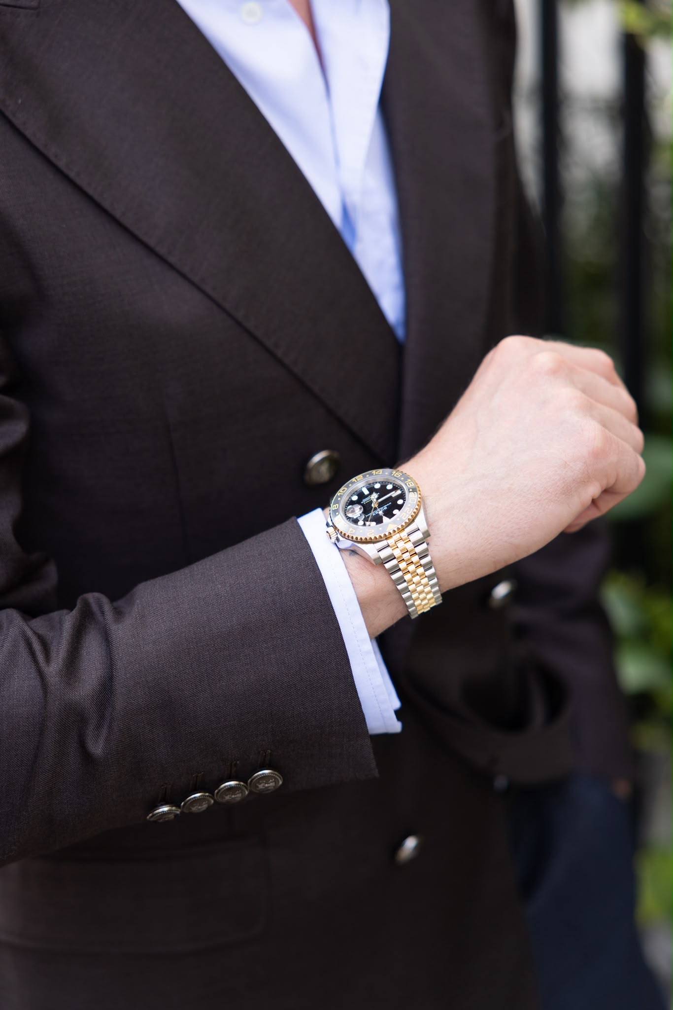 Gilberto Ramerini in a brown blazer, checking his watch
