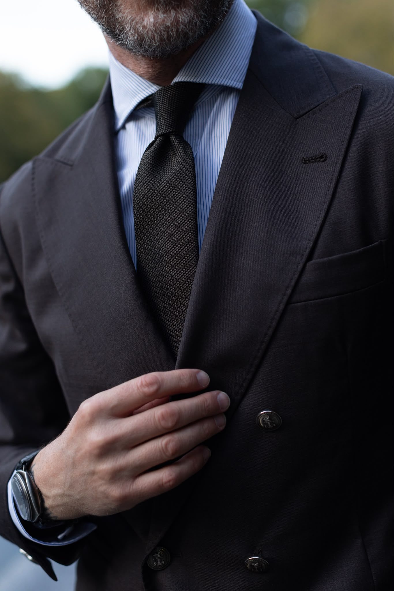 Gilberto Ramerini in a charcoal double-breasted suit, striped shirt and knitted tie