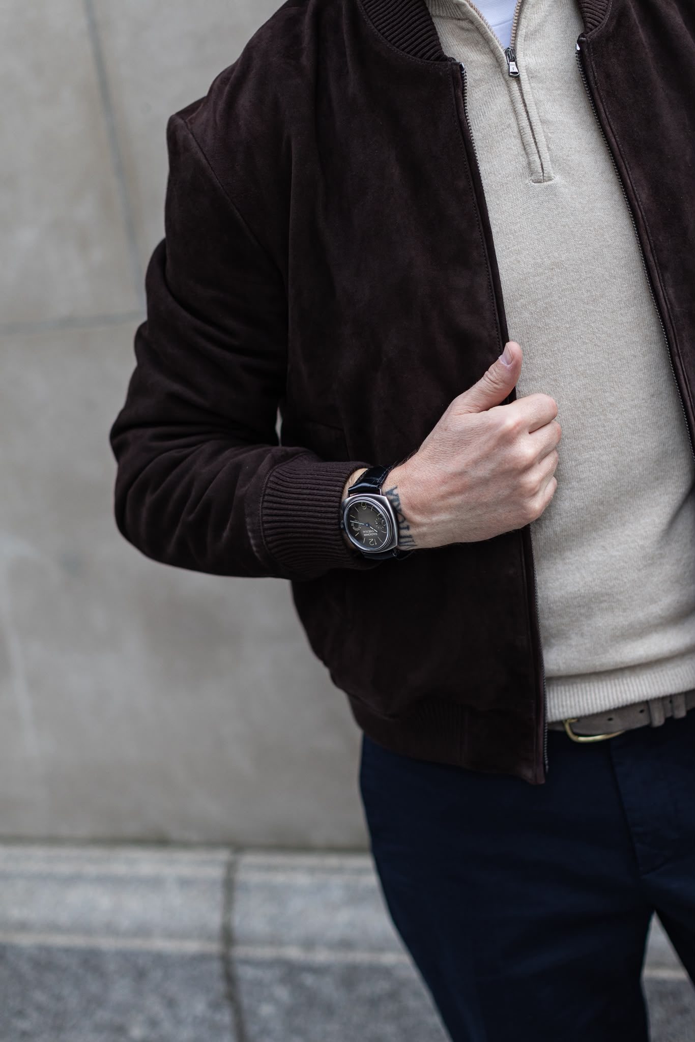 Gilberto Ramerini in a brown suede bomber and cream knit, with a watch at the cuff