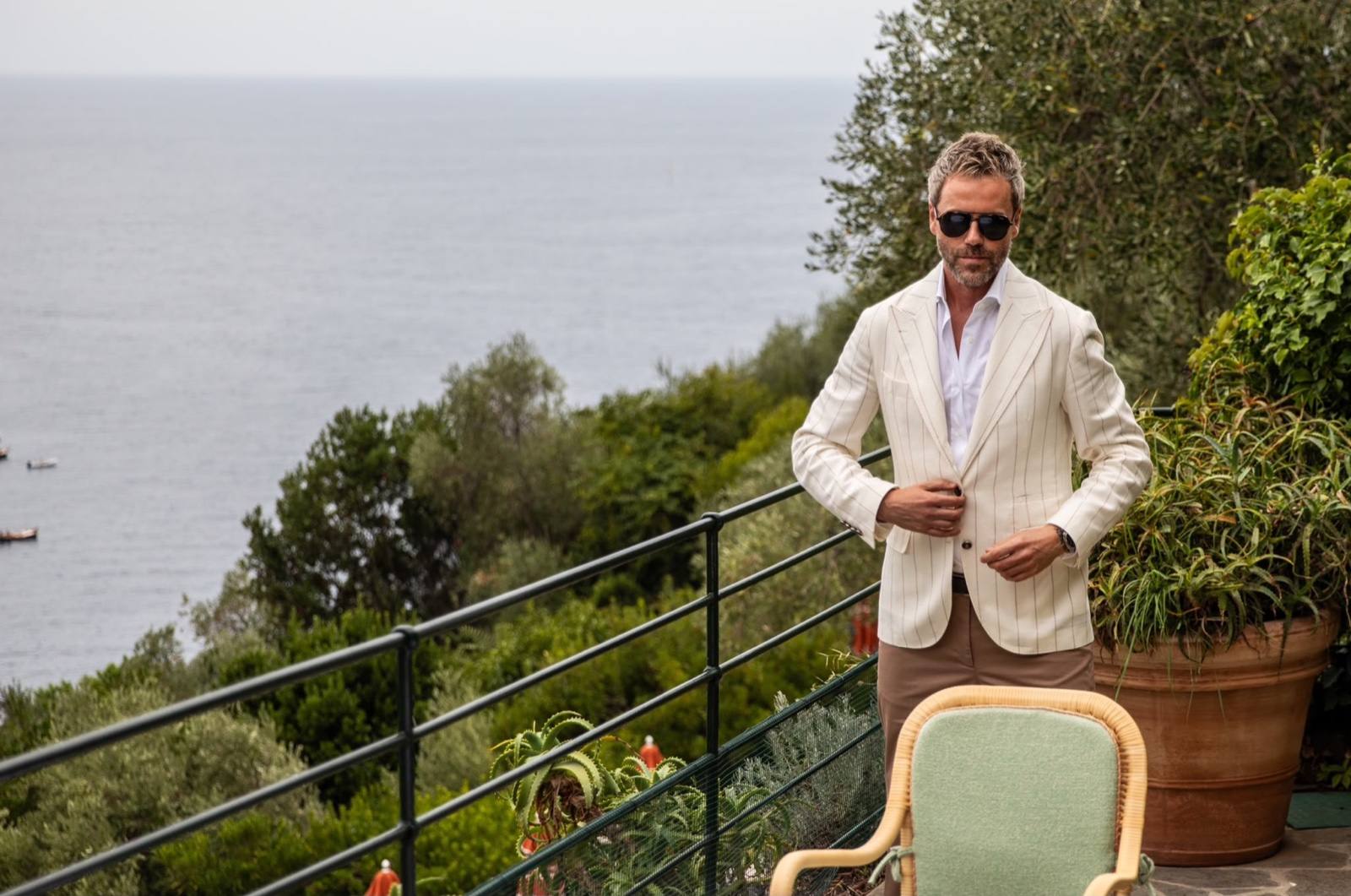 Gilberto Ramerini in a white pinstripe blazer on a terrace